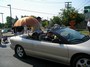 President Greg with Gus Sainsbury under the umbrella, and Al Walker riding shotgun.
